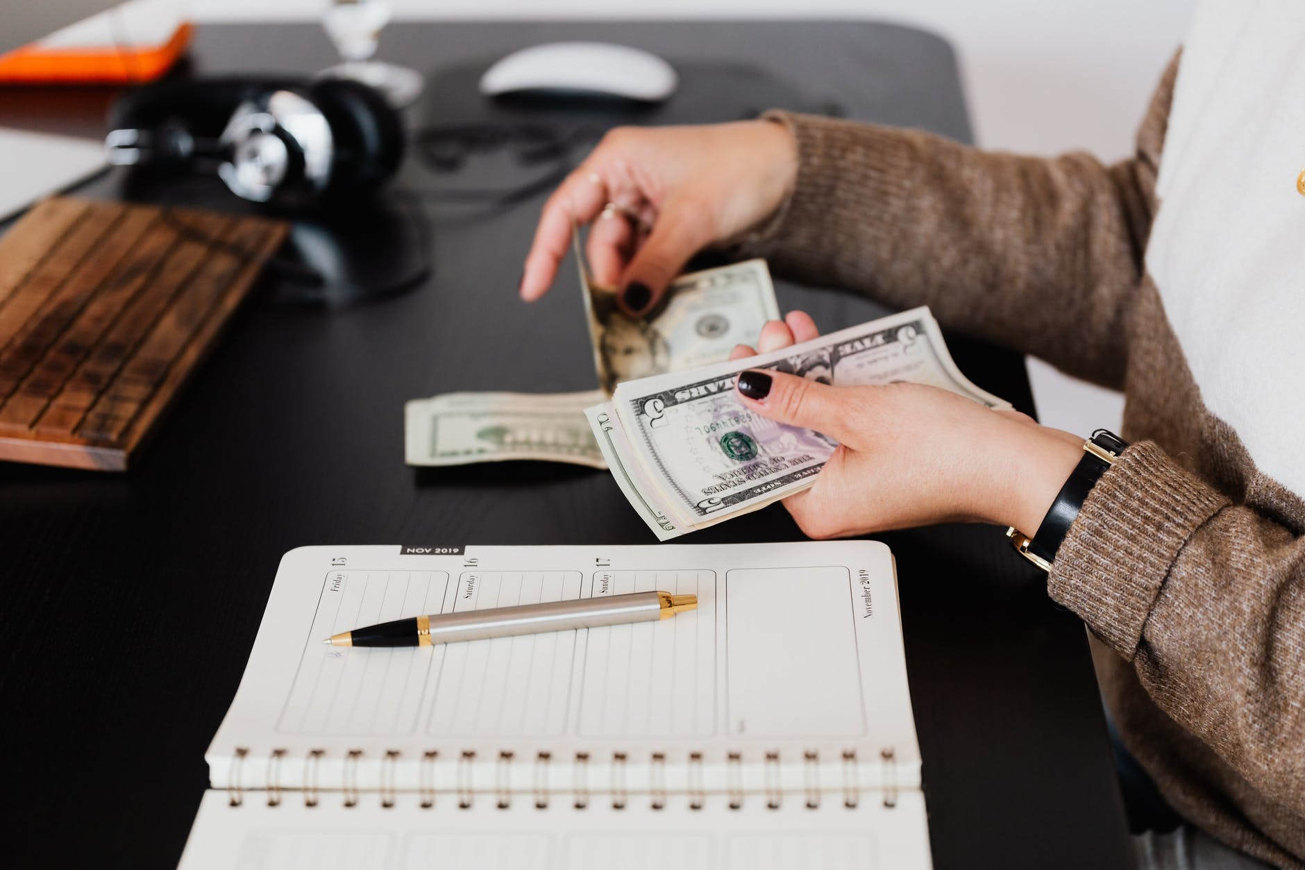 Woman counts money in office