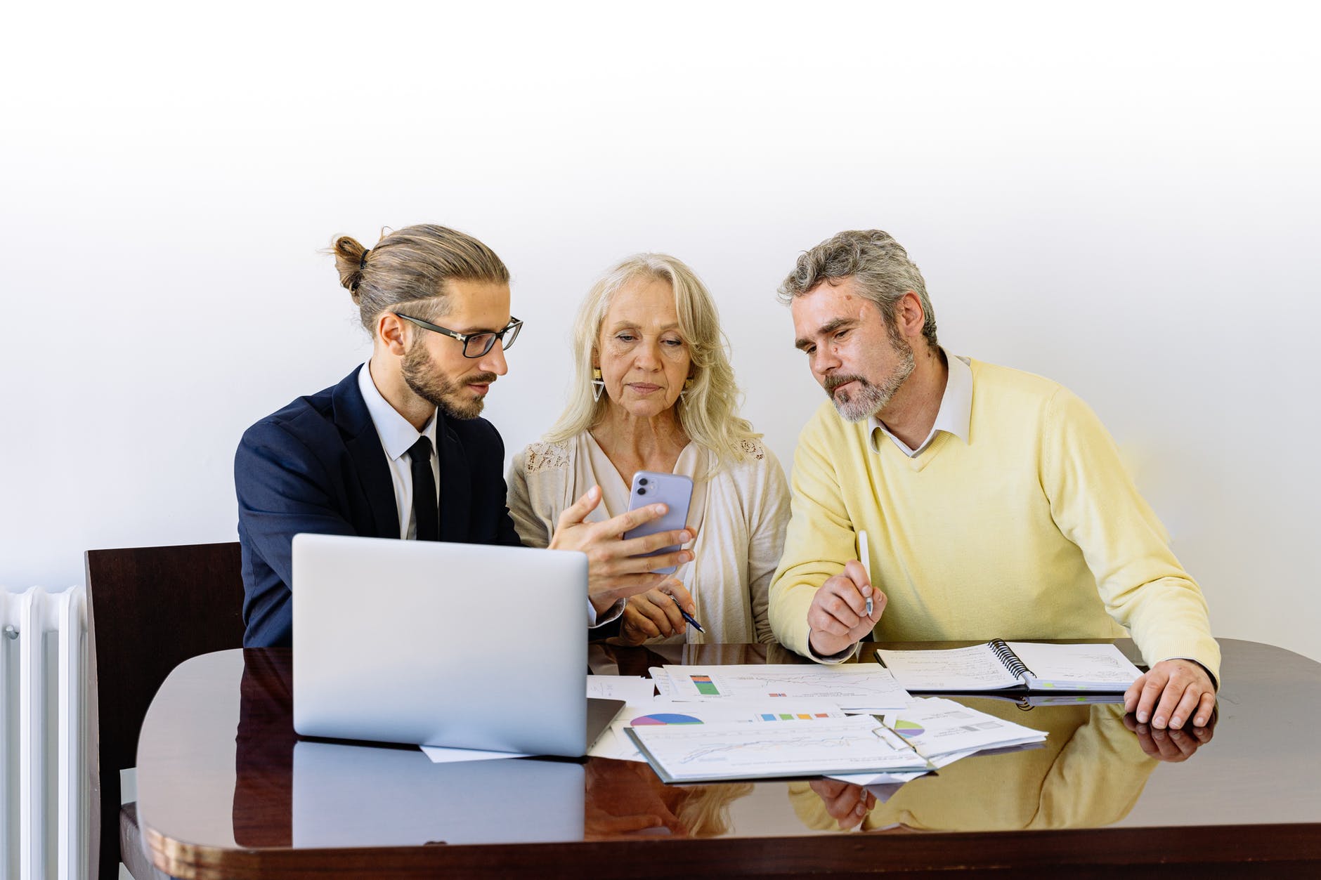 Professional business adviser is talking with adult couple